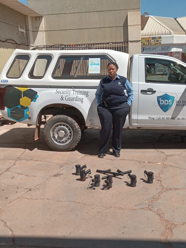 Officer standing by vehicle with security equipment