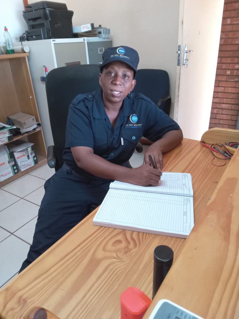 Security officer with cap at office desk