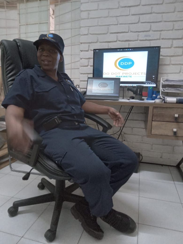 Officer at desk with Do Dot Projects on screen