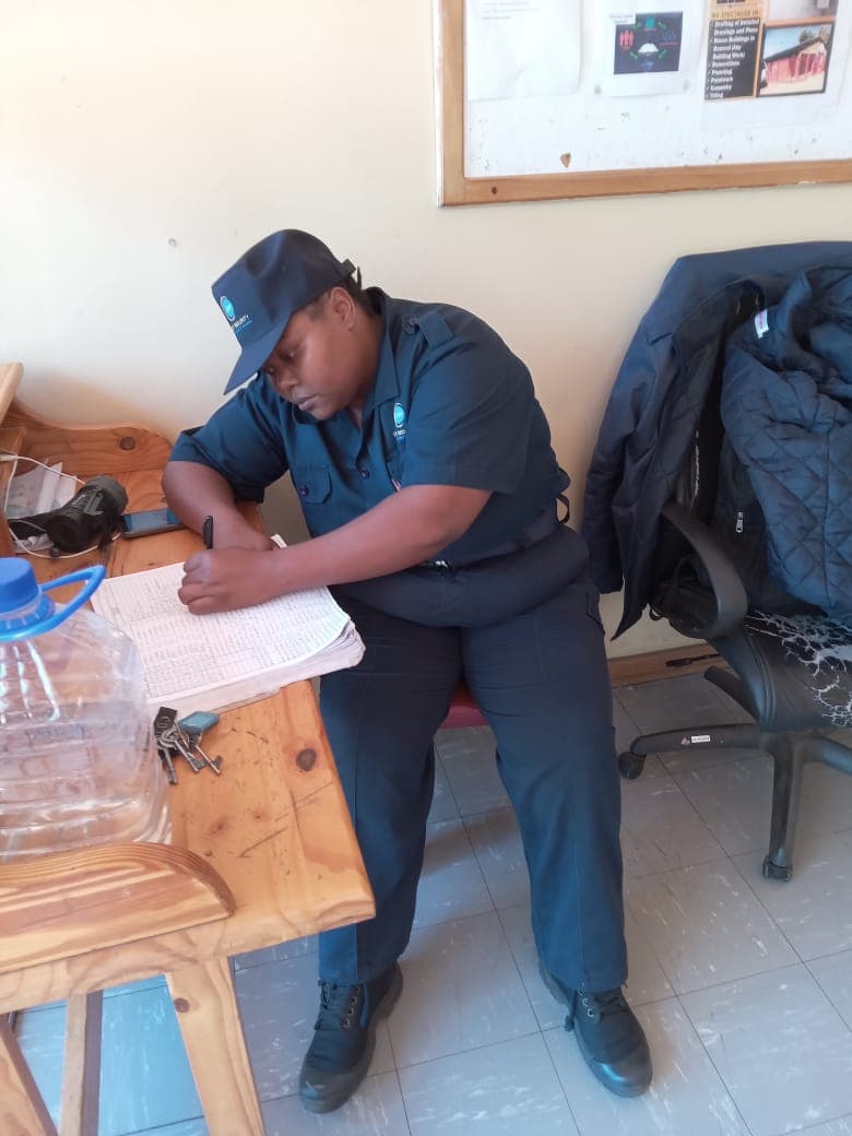 Officer writing in logbook during shift