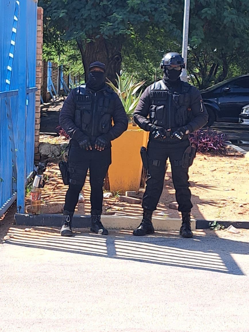 Two tactical response officers in full protective gear