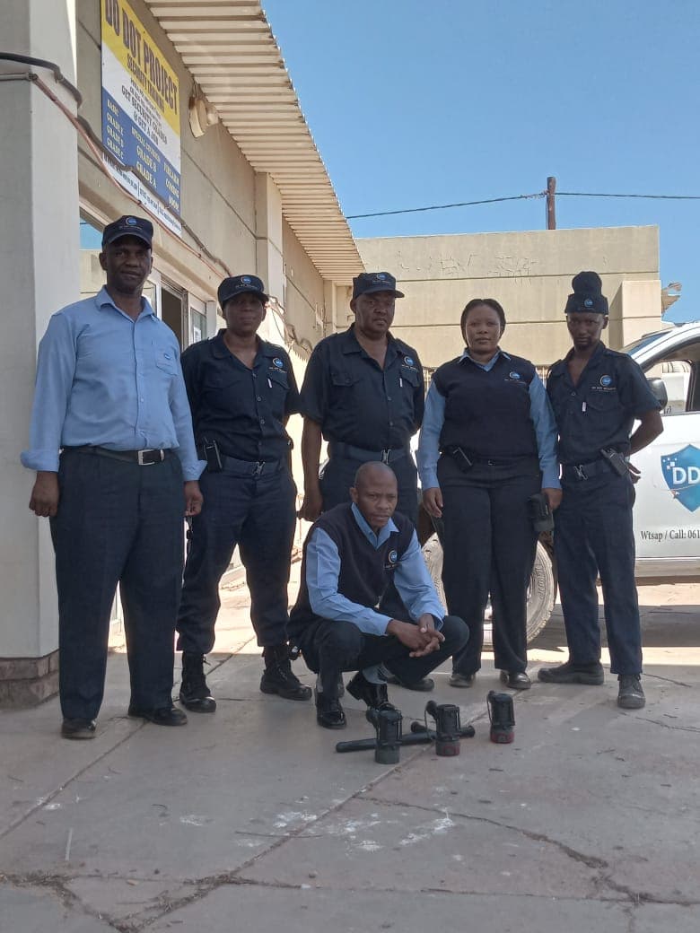 Security team group photo with crouching officer
