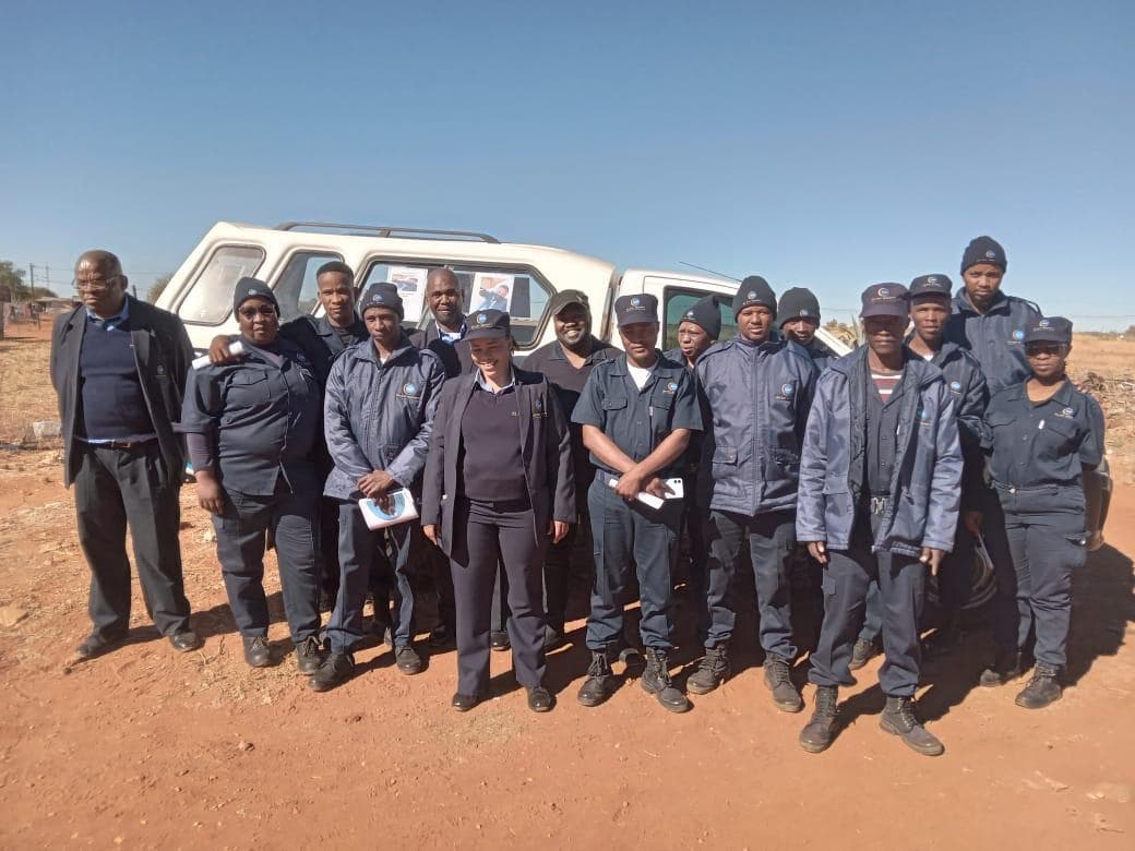 Large group of DDS security officers assembled by patrol van