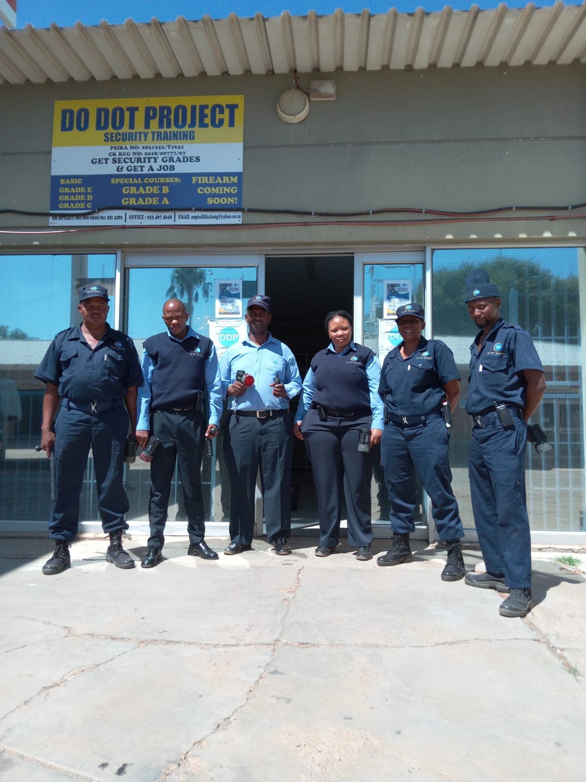 Do Dot Security team standing proudly at office entrance