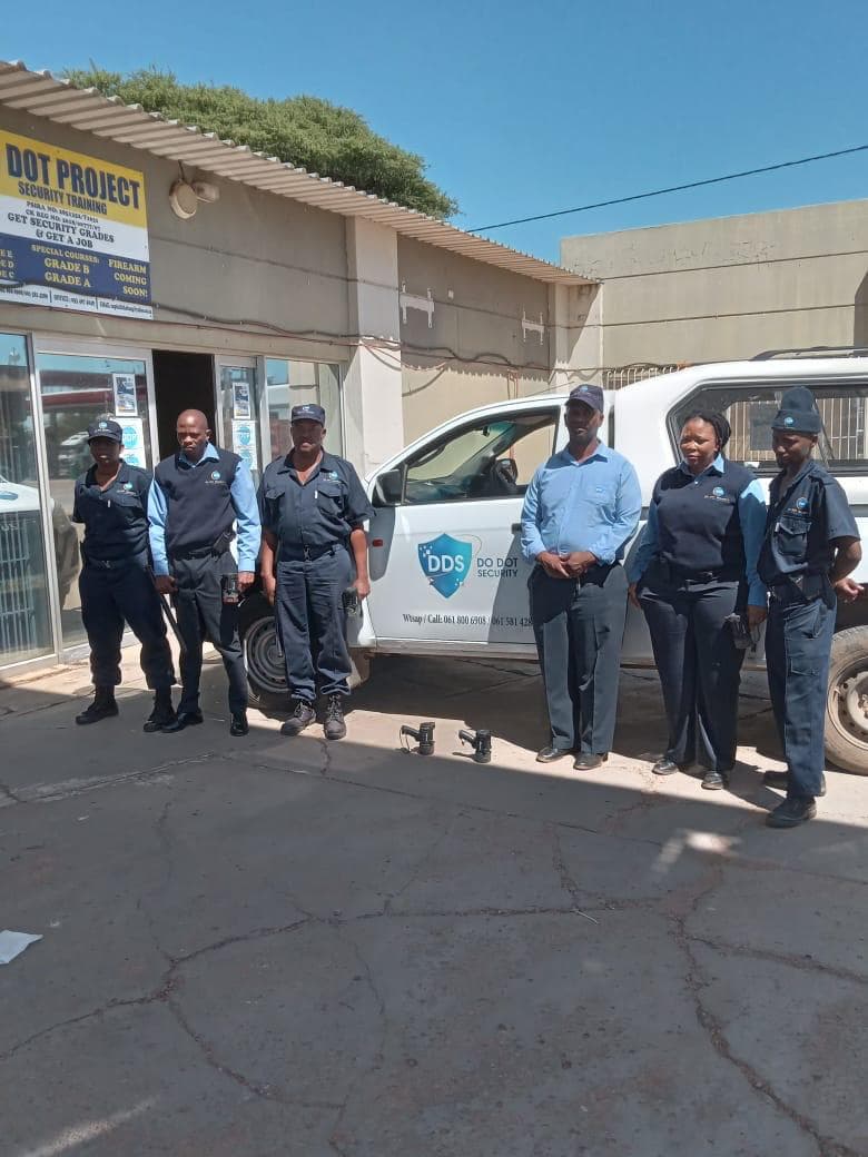 Security team standing outside Do Dot Project office with vehicle