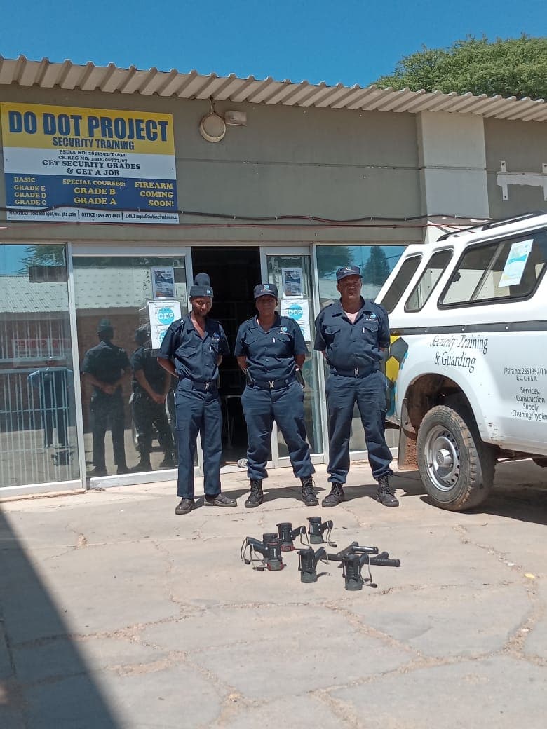 Three officers standing at Do Dot Project office entrance