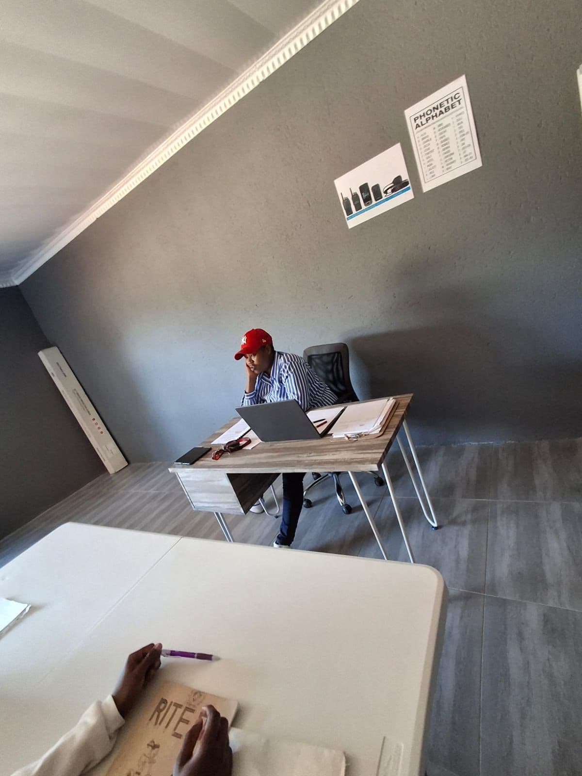 Training instructor at desk with laptop preparing lesson